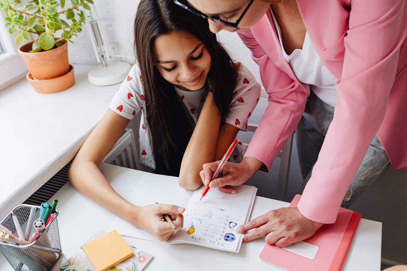 Teacher supporting a student with written work